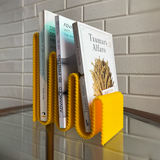 Yellow book holder with books on a tiled wall background