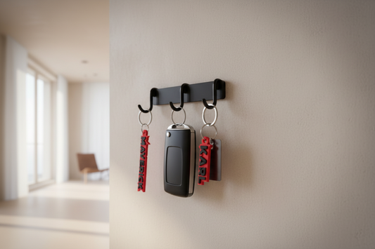 Key holder with keys on a wall in a room with large windows.