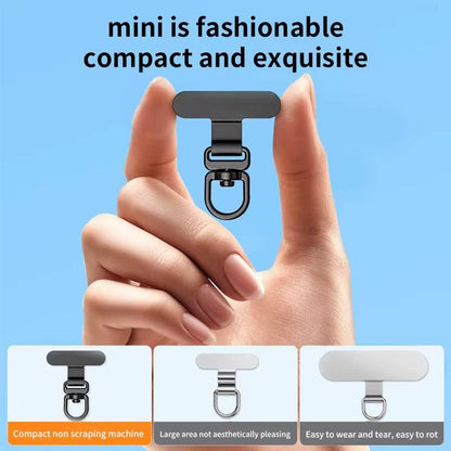 Small black clip held between fingers with text on a blue background