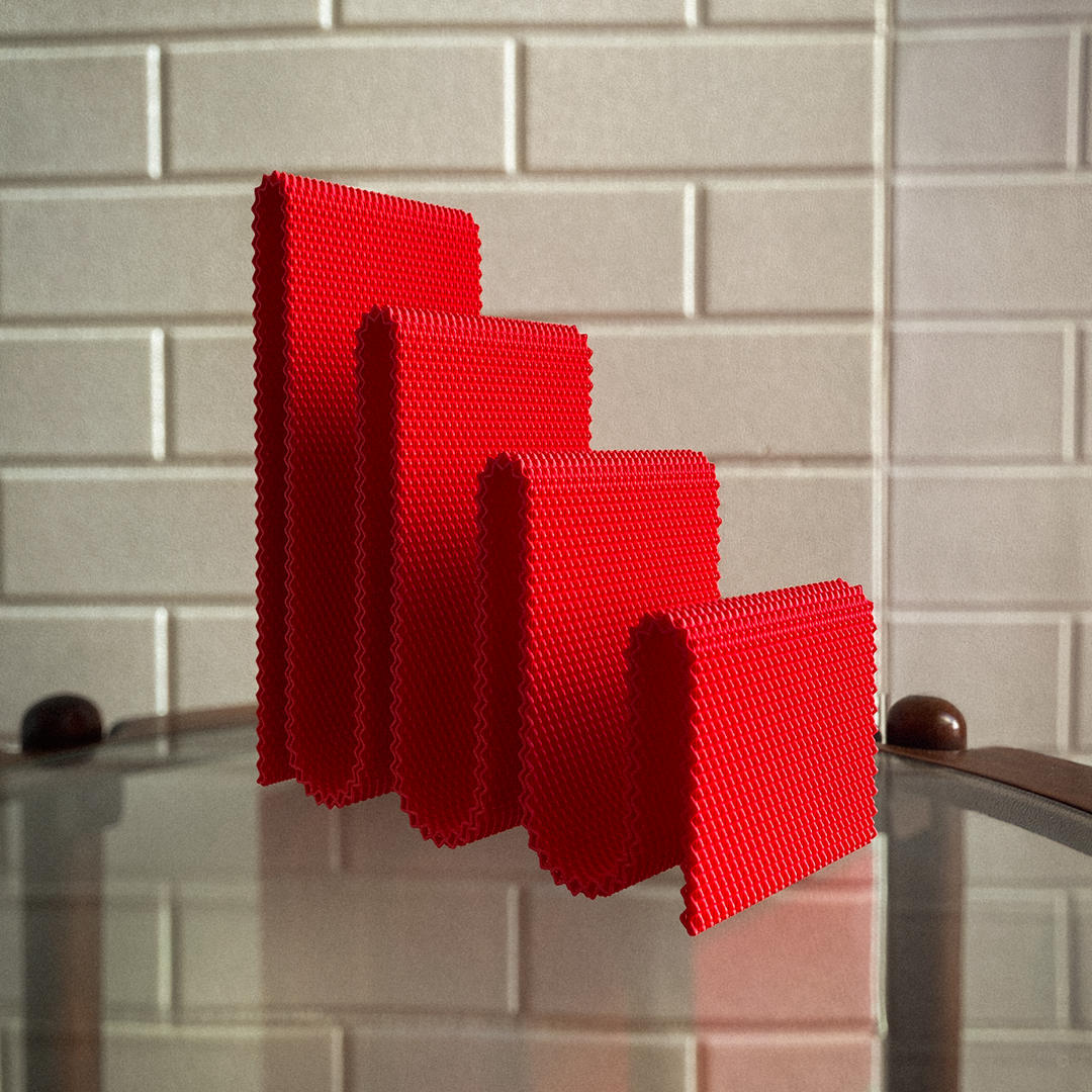 Red sponge on a kitchen sink with tiled wall background