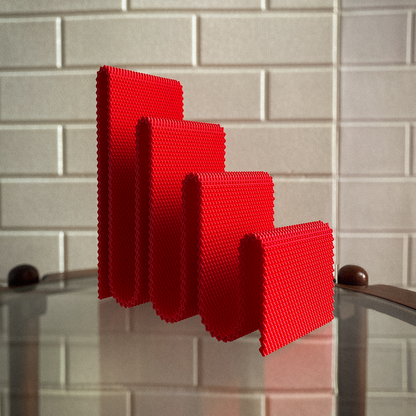 Red sponge on a kitchen sink with tiled wall background