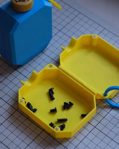 Yellow hexagonal tool box with screws on a grid background
