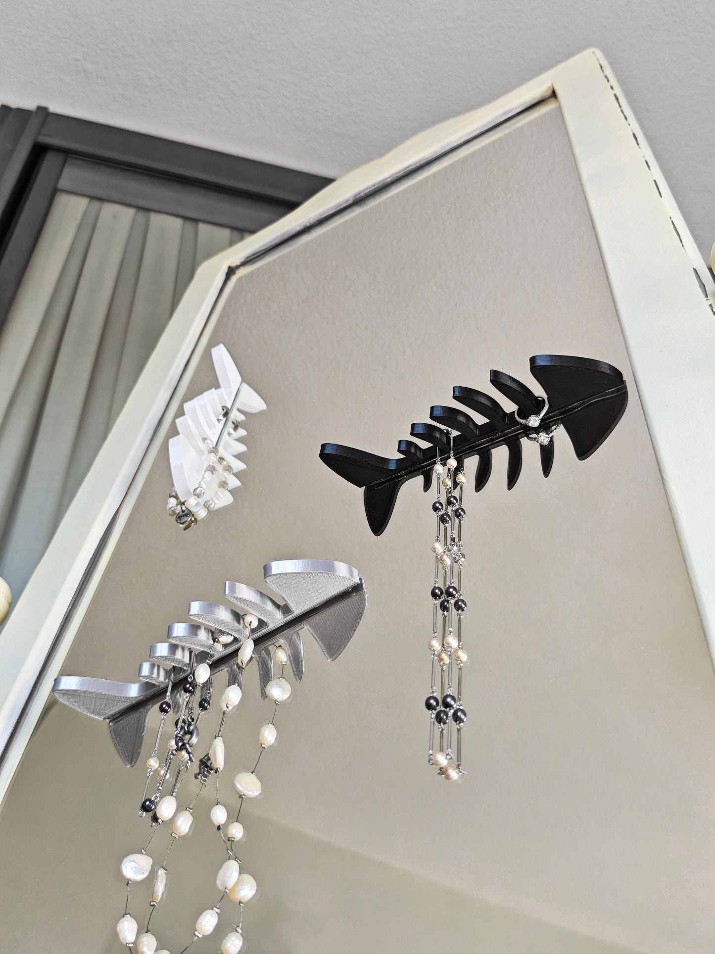 Earring organizer with hanging earrings on a mirror.