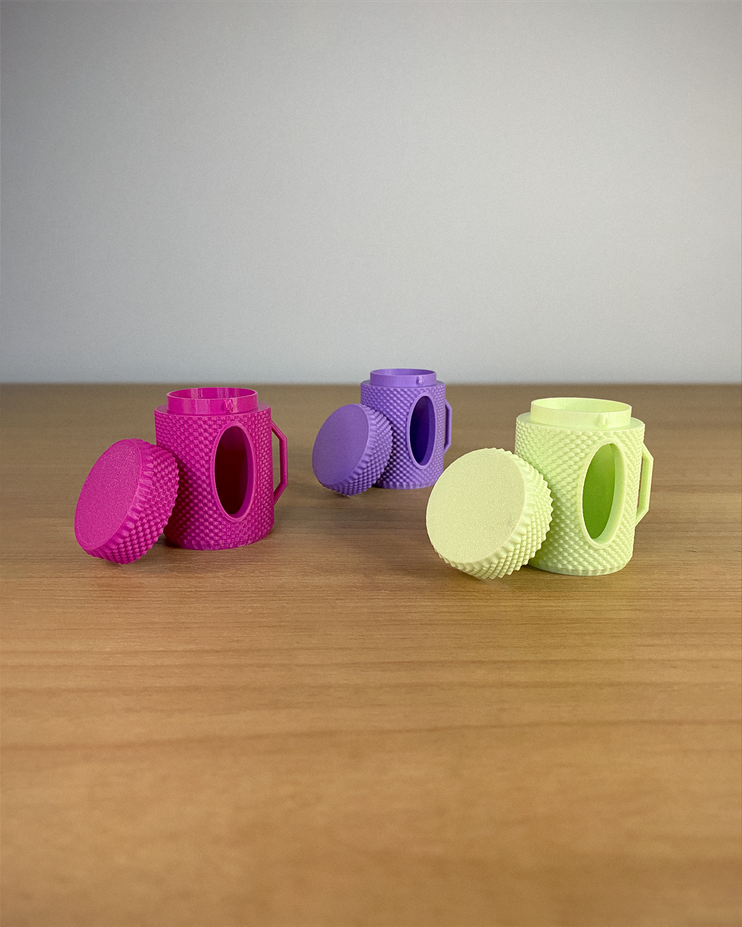 Set of colorful silicone kitchen tools on a wooden surface with a gray background