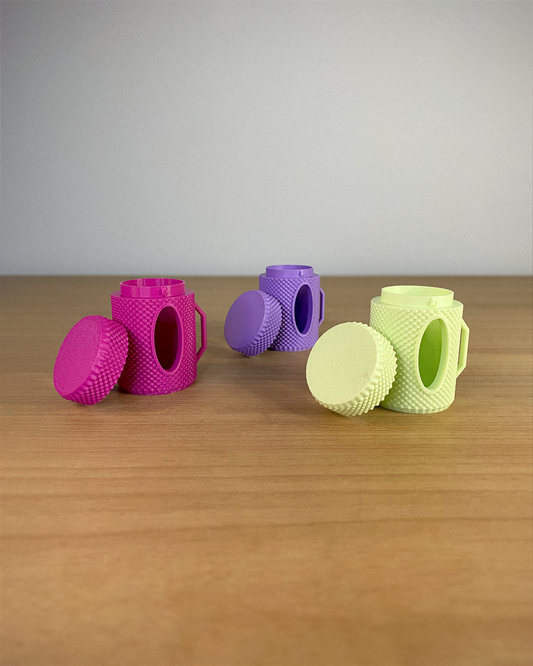 Set of colorful silicone kitchen tools on a wooden surface with a gray background