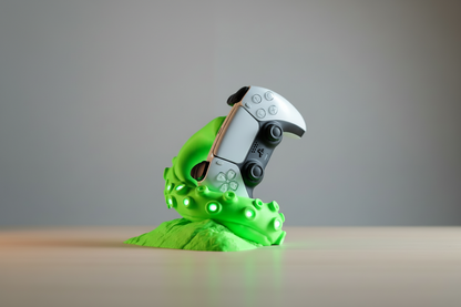 Video game controller with a green alien-like casing on a gray background